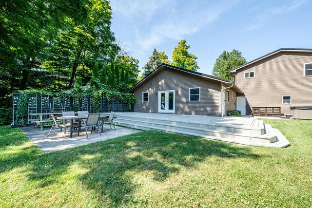 rear view of property with a yard and a deck