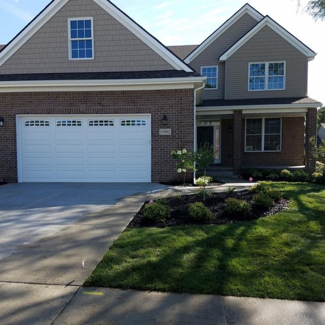 craftsman house featuring a front lawn and a garage