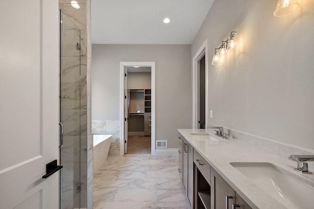 bathroom featuring vanity and shower with separate bathtub