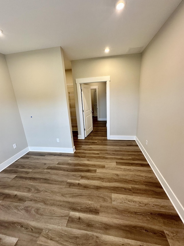 spare room with dark wood-type flooring