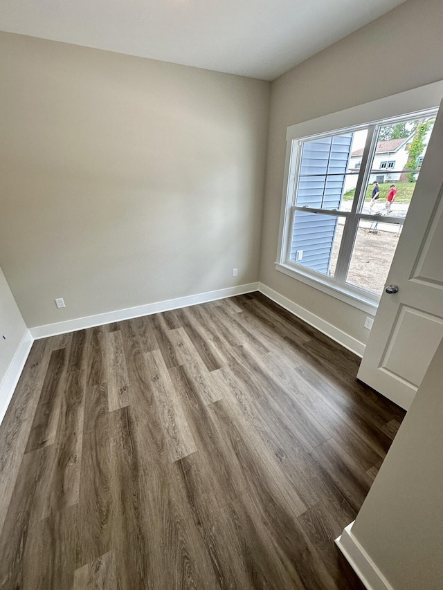 empty room featuring dark wood-type flooring