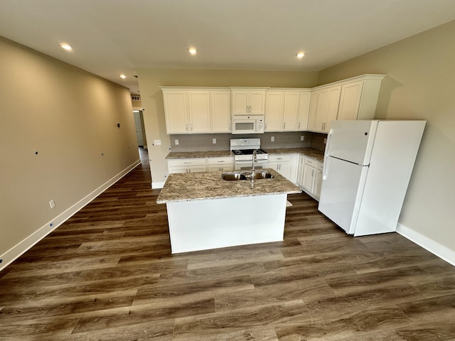 kitchen with dark wood-type flooring, sink, a center island with sink, white appliances, and white cabinets