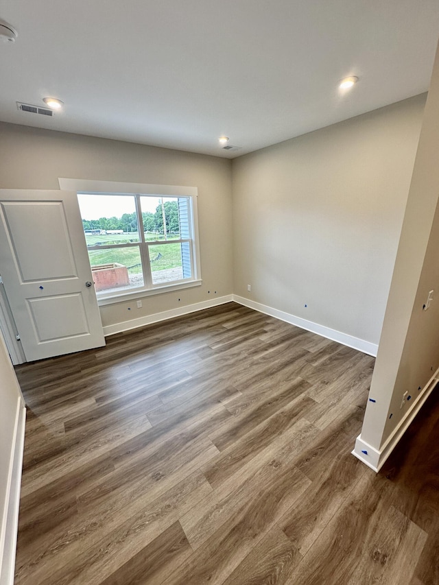 unfurnished room featuring dark wood-type flooring