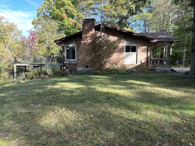 view of side of home with a lawn