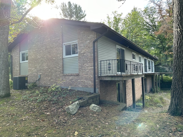 view of home's exterior featuring cooling unit and a deck