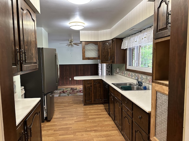 kitchen featuring dark brown cabinetry, sink, stainless steel refrigerator, dishwasher, and light hardwood / wood-style floors