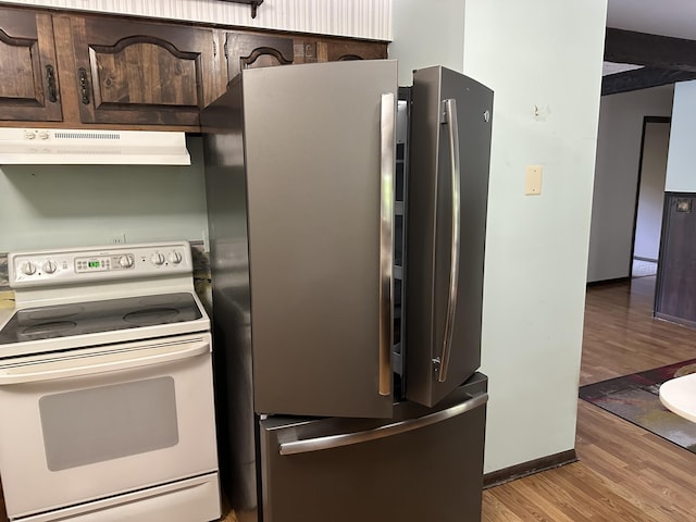 kitchen featuring white electric range, stainless steel fridge, dark brown cabinetry, and light hardwood / wood-style floors