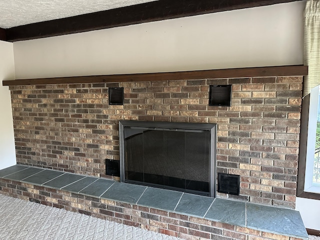 interior details with carpet flooring and a brick fireplace