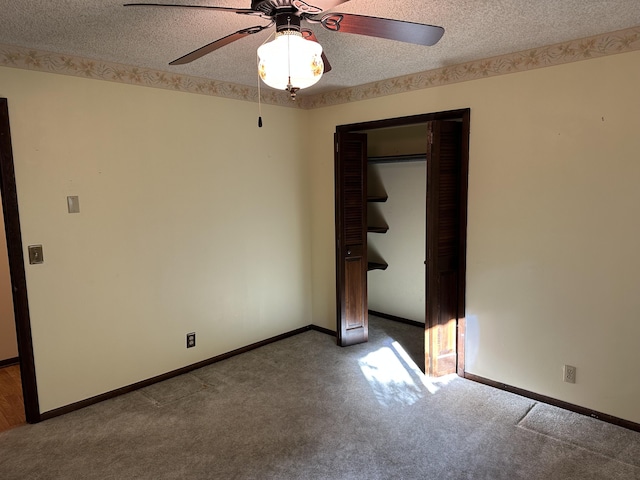 spare room featuring ceiling fan, carpet floors, and a textured ceiling