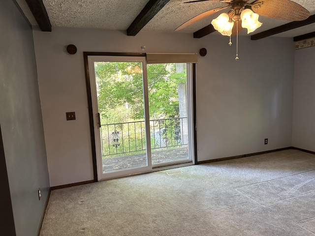 spare room with beamed ceiling and light carpet