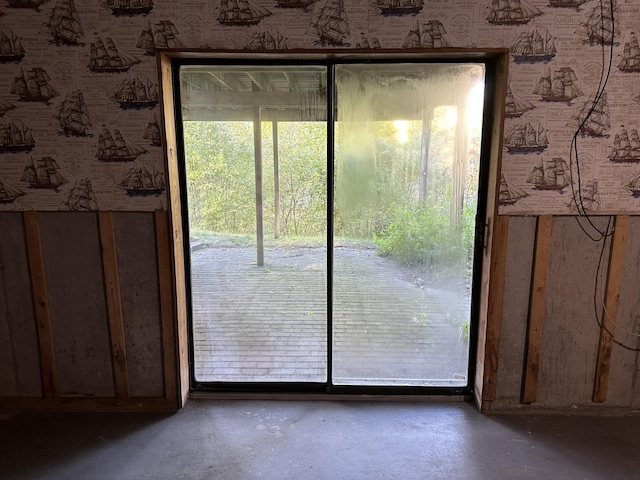 doorway to outside with concrete flooring