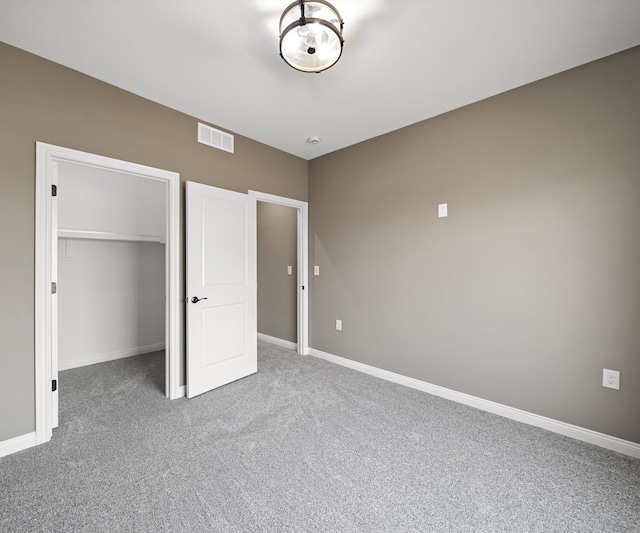 unfurnished bedroom featuring carpet floors and a closet