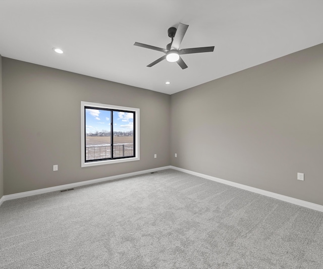 carpeted empty room with recessed lighting and baseboards