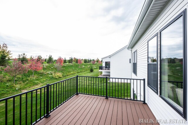 wooden deck with a lawn