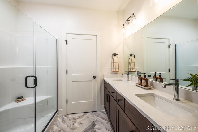 bathroom featuring double sink vanity, tile patterned floors, and a shower with shower door