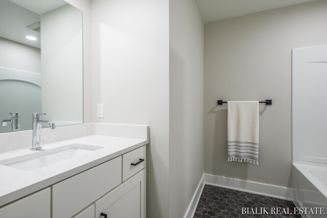 bathroom with tile patterned flooring and vanity