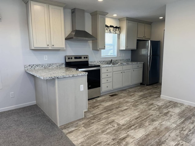 kitchen featuring light hardwood / wood-style floors, wall chimney exhaust hood, electric range, and black fridge