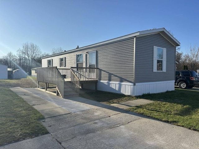 view of home's exterior with a deck and a yard