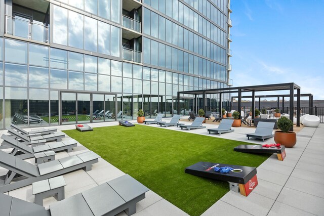 view of community with a patio area and a yard