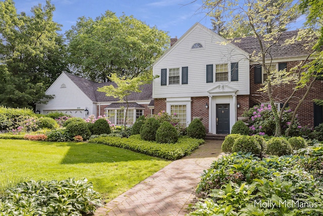 view of front of house featuring a front yard and a garage