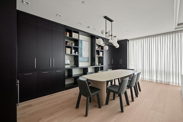 dining area featuring visible vents and light wood finished floors