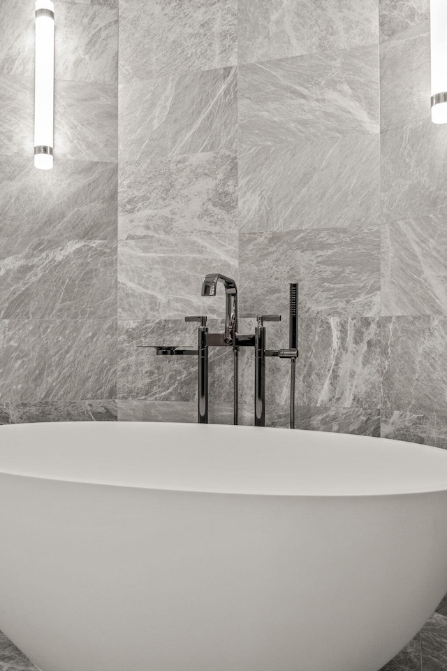 bathroom with a sink and a freestanding tub