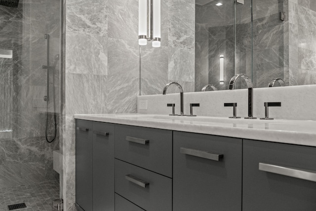 bathroom featuring backsplash, walk in shower, vanity, and tile walls