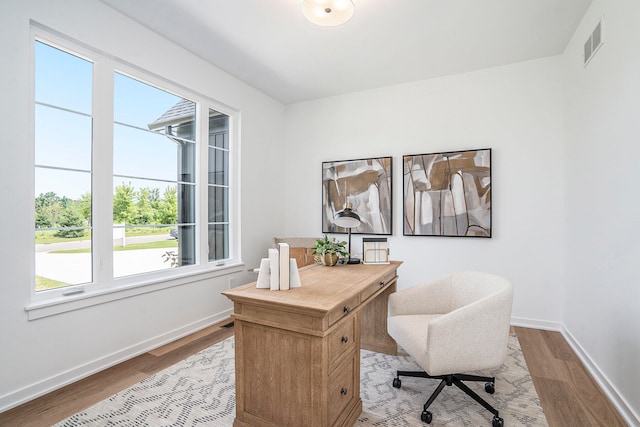 office area with light hardwood / wood-style floors