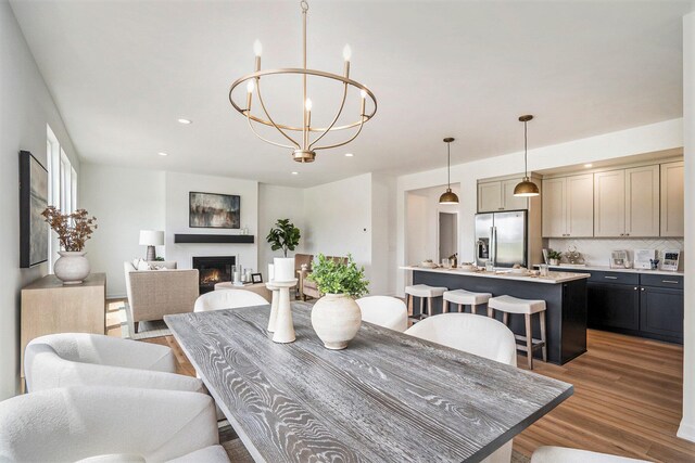 dining room featuring wood-type flooring and an inviting chandelier