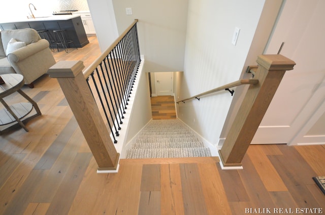 stairs with light wood-type flooring