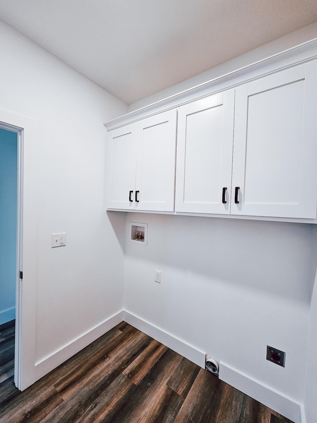 clothes washing area with cabinets, hookup for a washing machine, and dark wood-type flooring