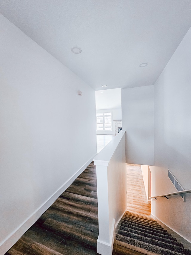 stairs featuring hardwood / wood-style floors