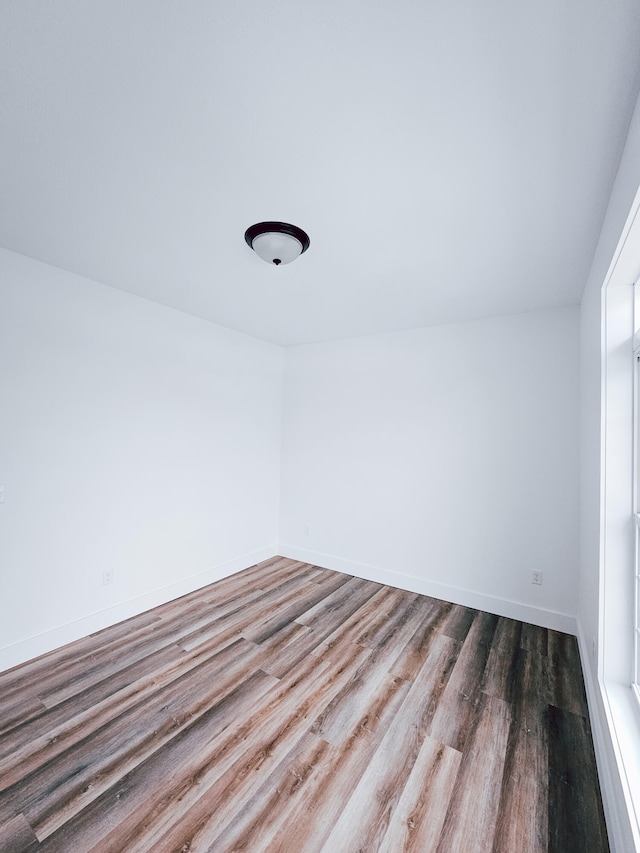 empty room with wood-type flooring