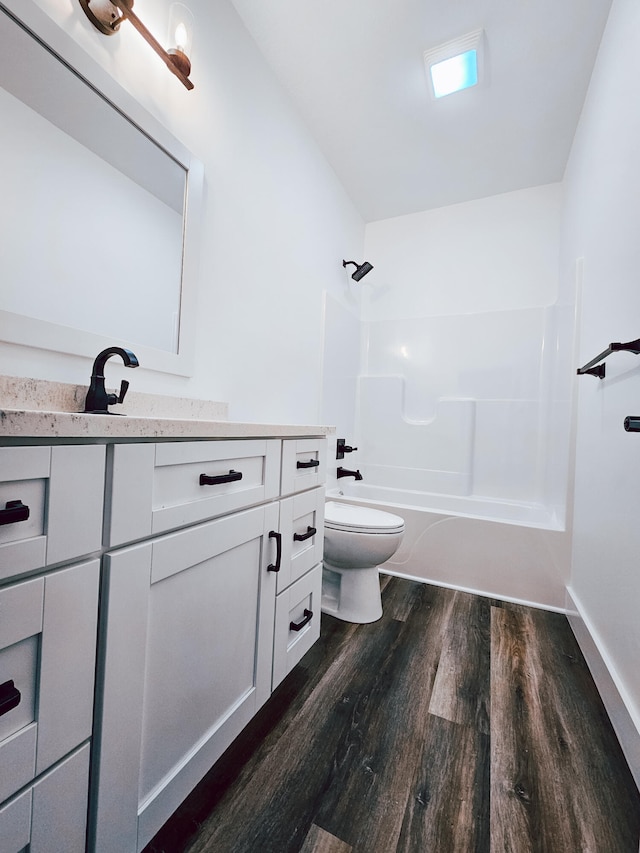 full bathroom with shower / bathtub combination, vanity, toilet, and hardwood / wood-style flooring