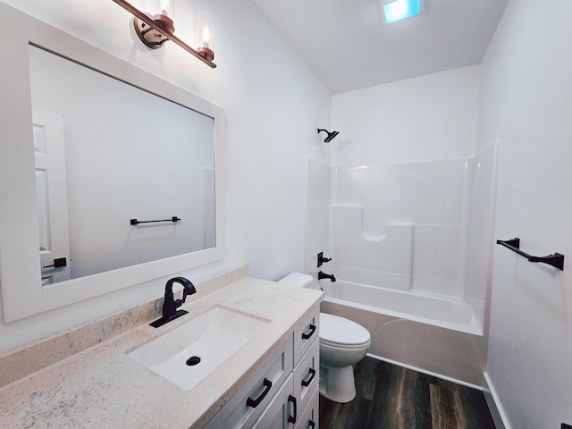 full bathroom featuring vanity, toilet,  shower combination, and hardwood / wood-style flooring