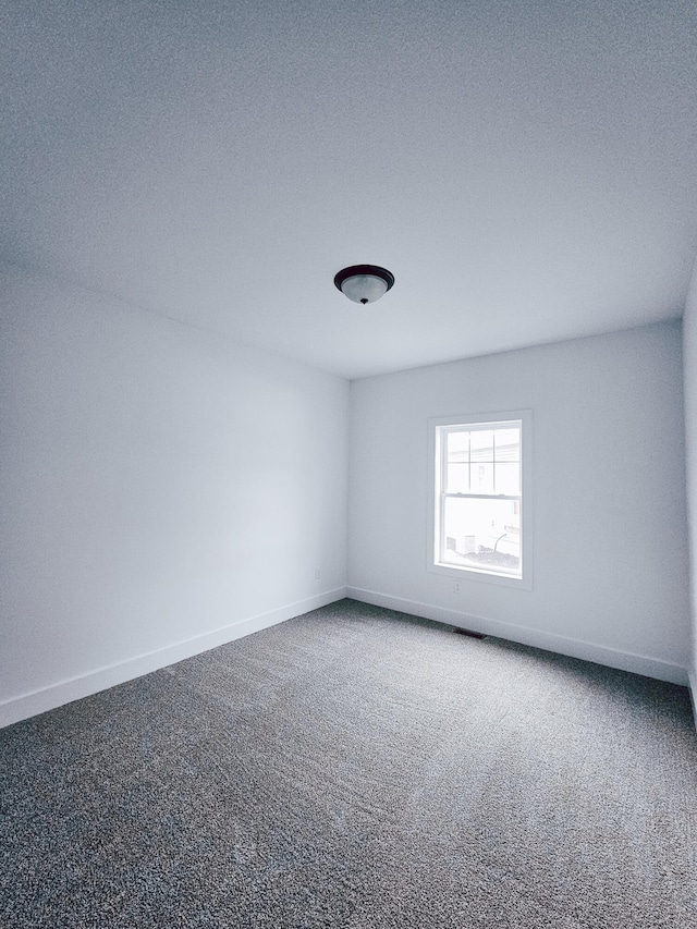 carpeted spare room with a textured ceiling