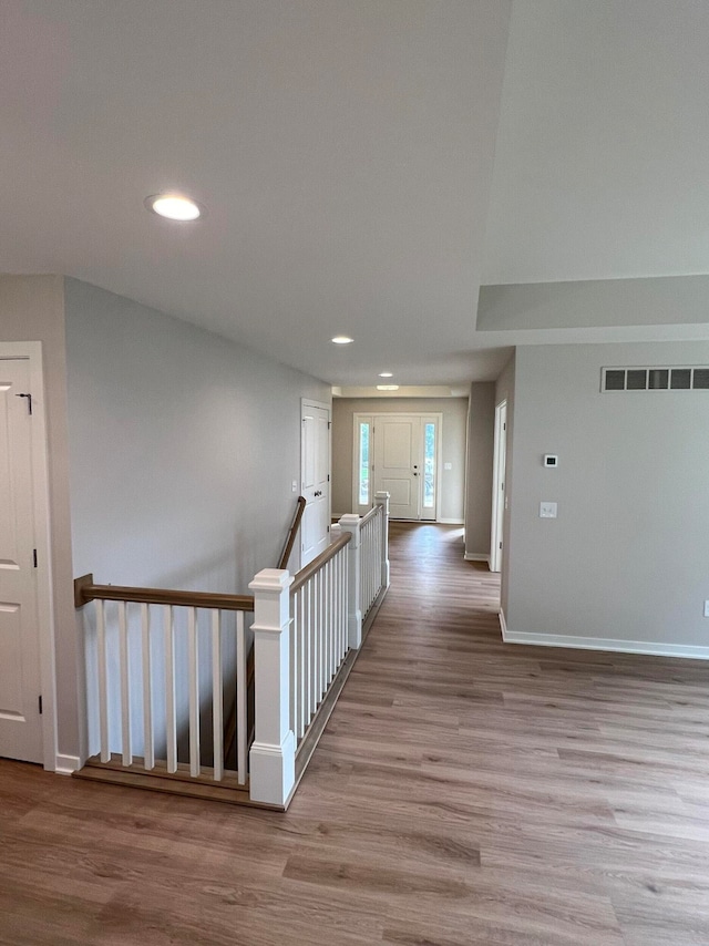 corridor with light hardwood / wood-style floors