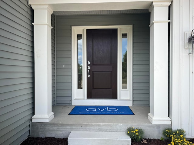 view of exterior entry with a porch