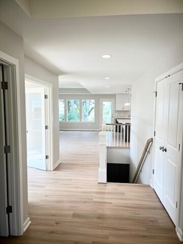 corridor featuring light hardwood / wood-style floors