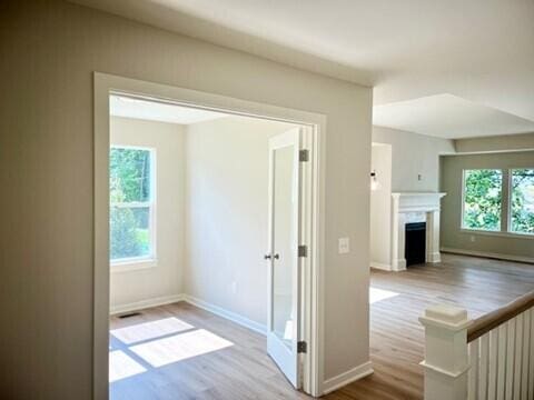 hall with light hardwood / wood-style flooring