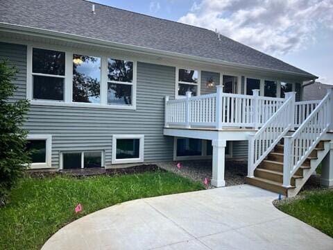 back of property featuring a patio and a wooden deck