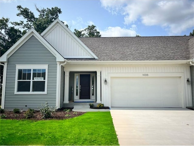 view of front facade featuring a front yard and a garage