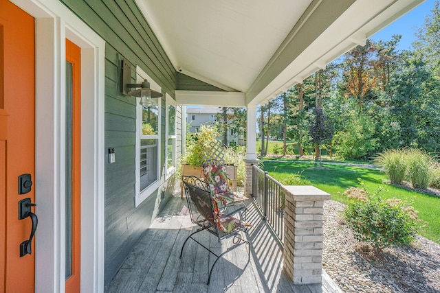 wooden deck featuring a lawn