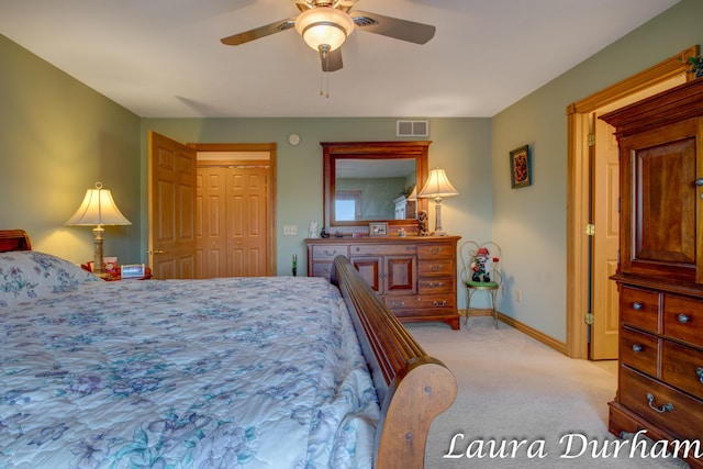 carpeted bedroom featuring ceiling fan and a closet