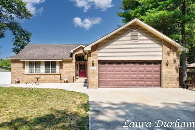 ranch-style house featuring a garage and a front lawn