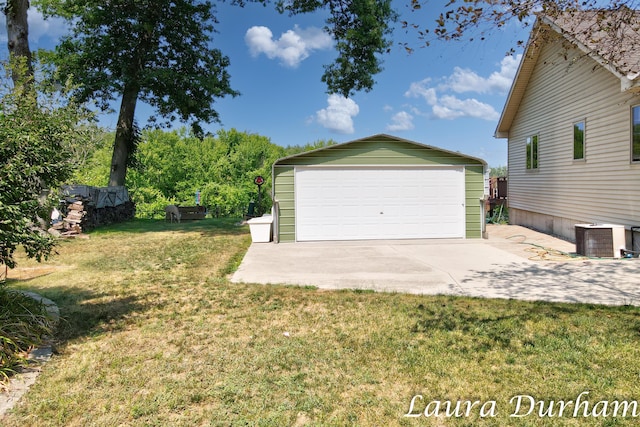 garage with cooling unit and a lawn