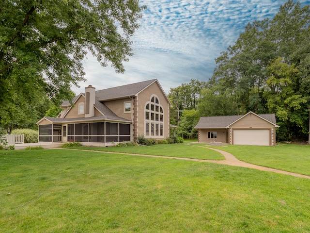 back of property featuring a lawn and a garage