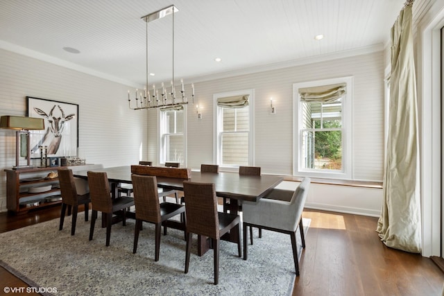 dining space with hardwood / wood-style flooring and crown molding