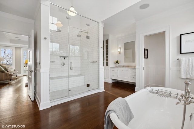 bathroom featuring hardwood / wood-style flooring, plus walk in shower, and vanity