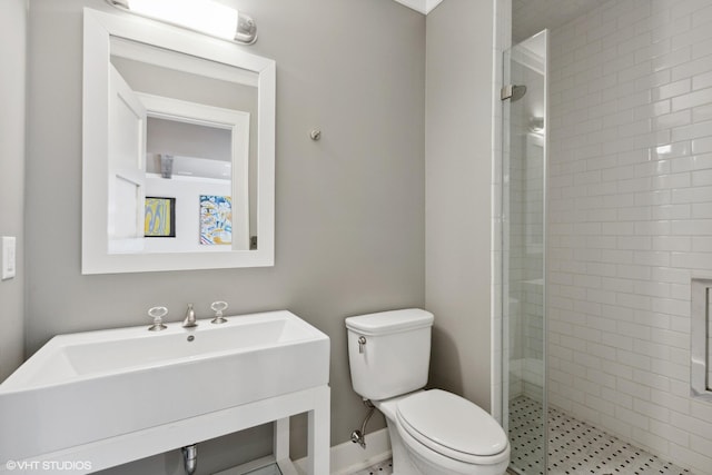 bathroom featuring sink, toilet, and walk in shower